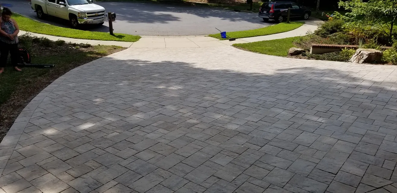Herringbone paver driveway viewed from the street, cul-de-sac visible
