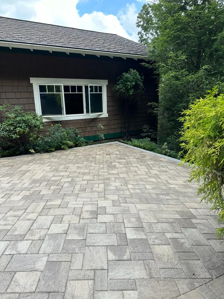 Paver patio area near a craftsman-style home, close-up view